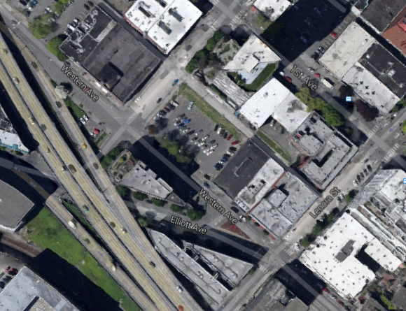 The parking lot on Western Ave is the development site, courtesy of Google Maps.