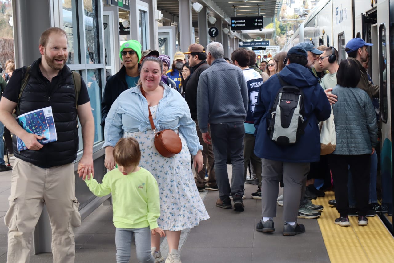 A crowded platform were riders try to cram onto full trains.