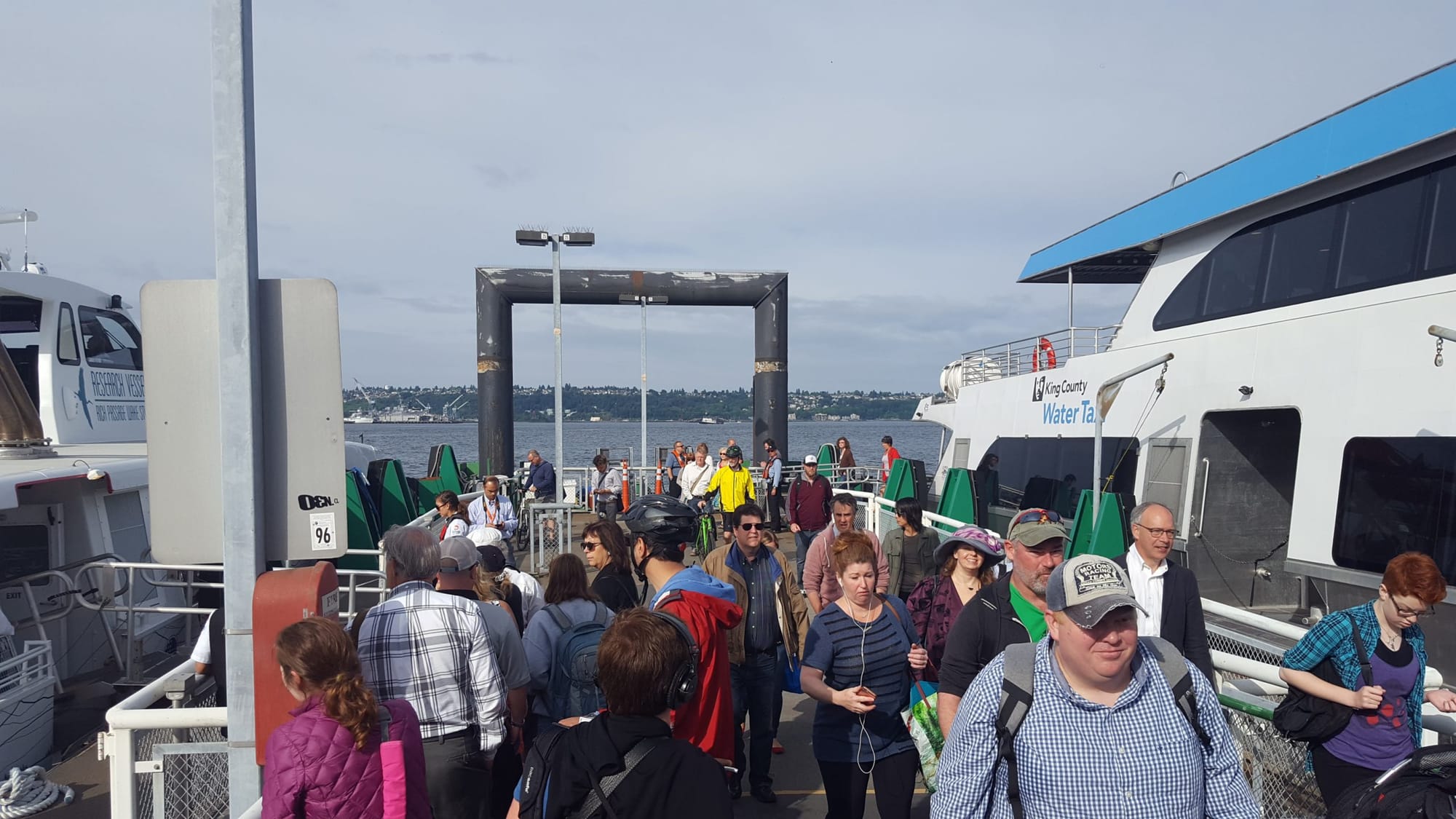 
                     Passengers on Colman Dock with a ferry docked.
                     