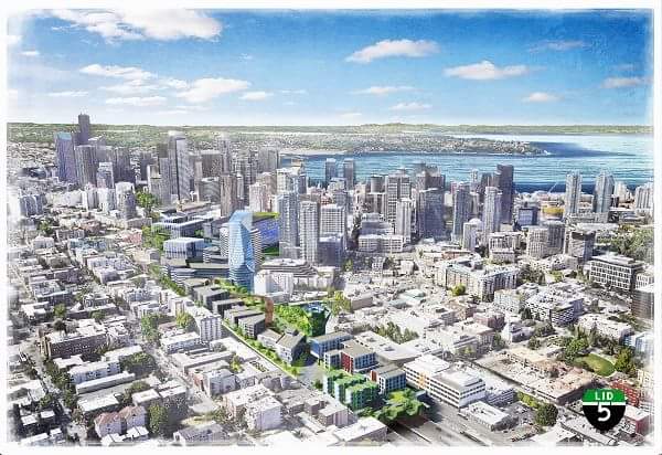 An aerial view of Downtown Seattle with the I-5 trench capped by green space, mid-rise housing, and a few towers, too.