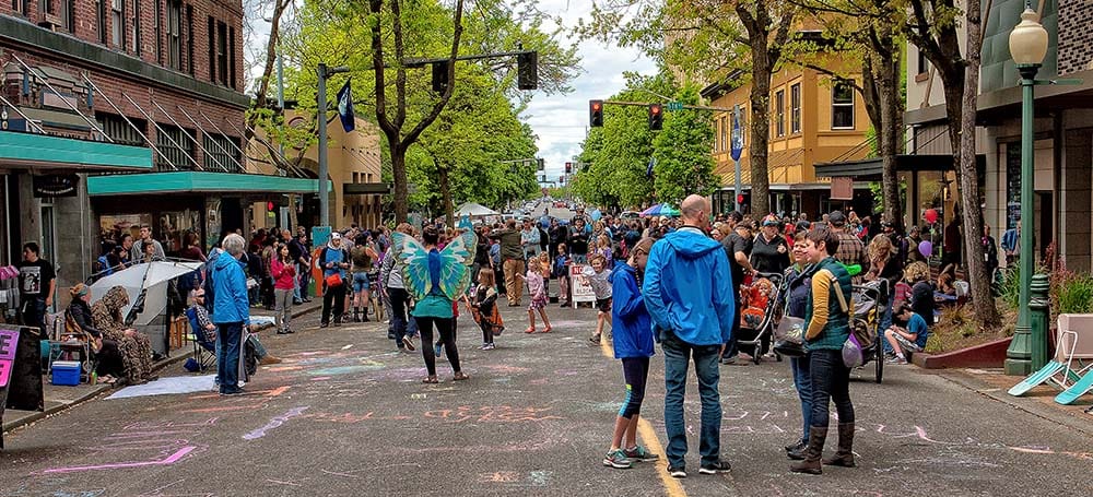 
                     People throng the street closed for a festival.
                     