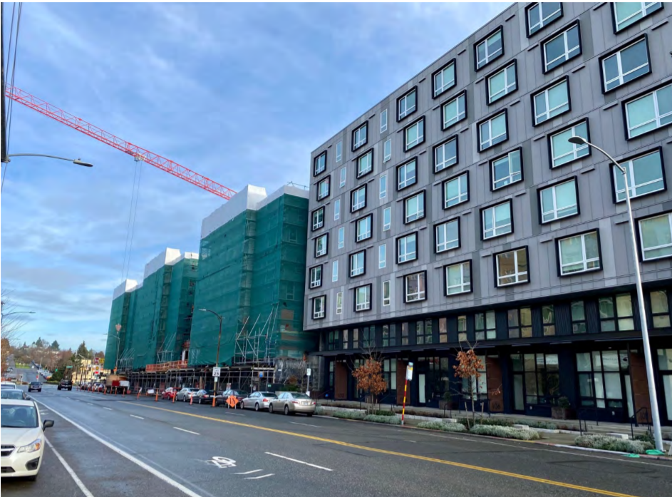 Seven story apartments abut the busy 80-foot arterial Fauntleroy Way.