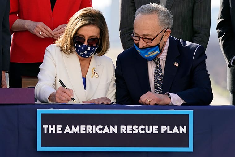 House Speaker Nancy Pelosi of California signs the $1.9 trillion COVID-19 relief bill. (Courtesy of AP Photo/Alex Brandon)