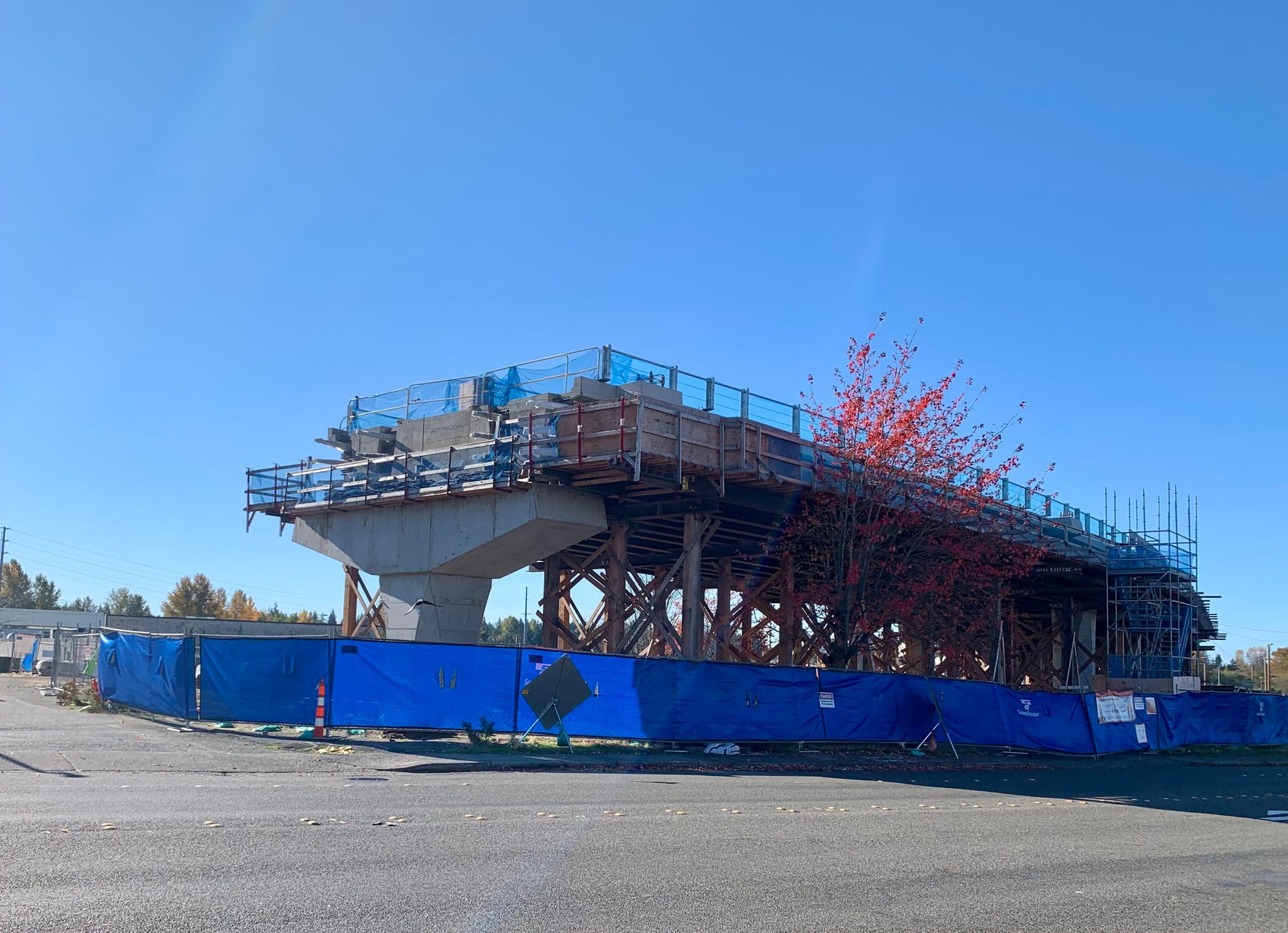 A photo a concrete pillar where light rail tracks under construction end. 