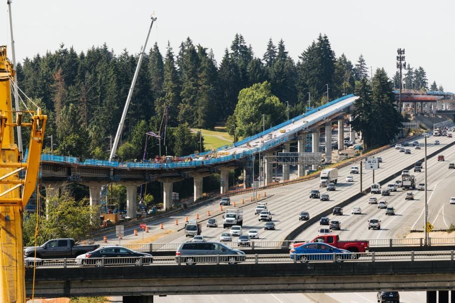 A photo of a concrete overpass over a highway. 