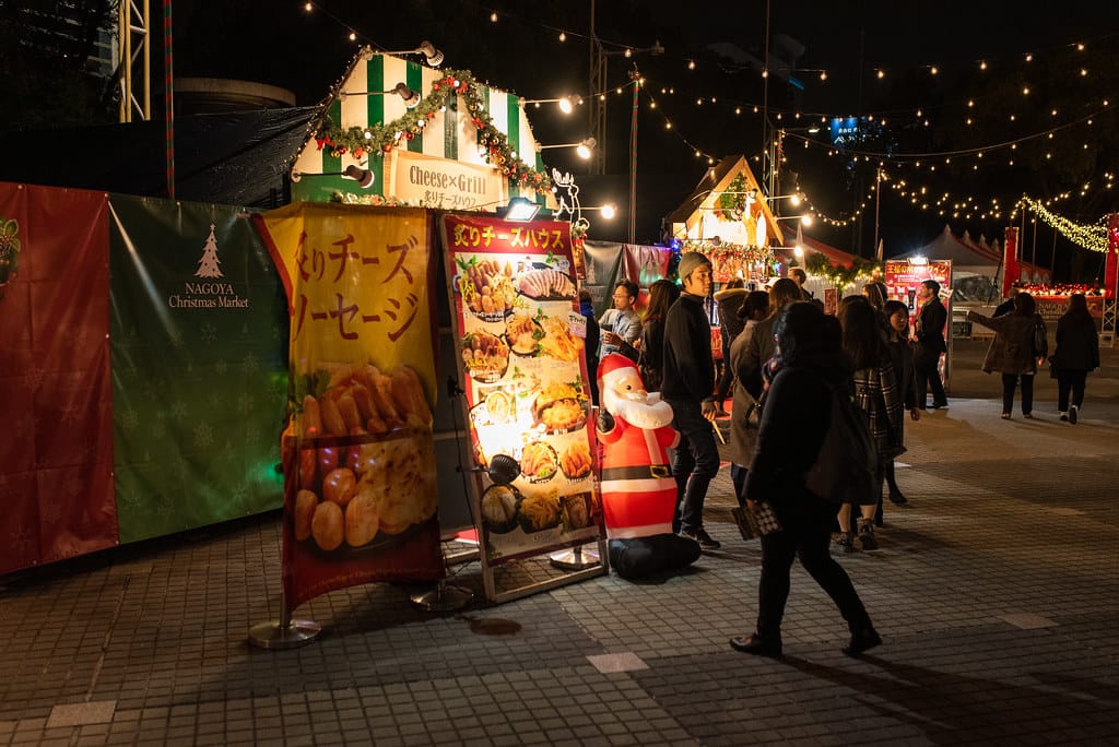 Advertisements for food amid copious Christmas decorations and lights. 