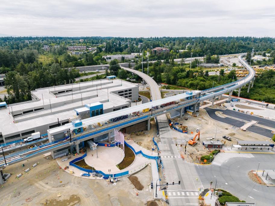 A bird's eye view of an elevated station and parking garage.