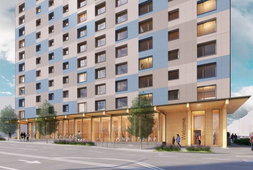 A rendering shows lots of full windows on the first floor and a gray and blue facade on the building above.