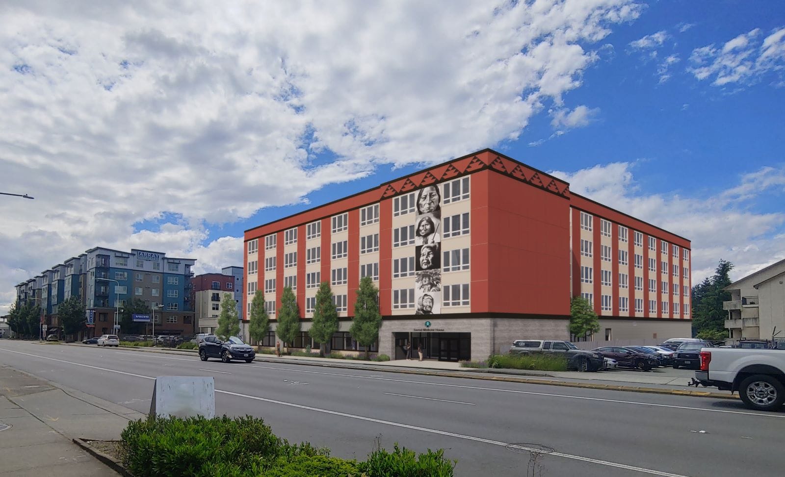 A five-story orange building with a similar building in the background.