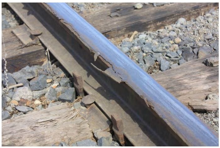 A closeup up of a deteriorating, flaking rail