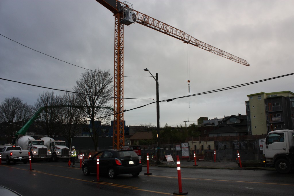 Workers are pumping concrete in the parking pit at 3627 Stone Way N.