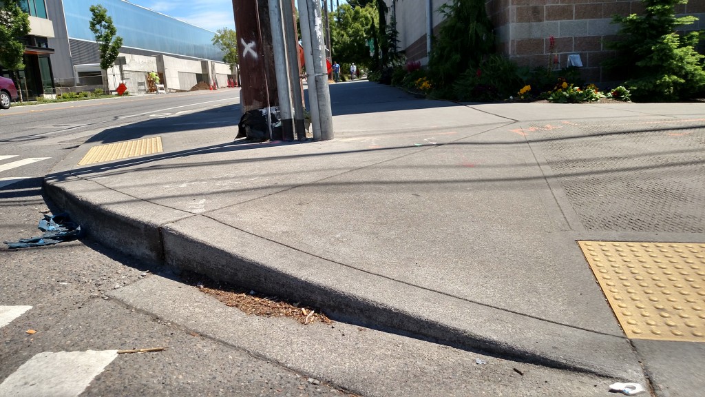 If I were transportation czar, I'd remove the utility pole to make a clear less cluttered path for all the pedestrians and bicyclists trying to negotiate this busy intersection. 