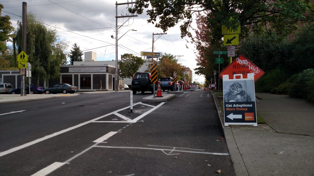 Big bike lane, mid-block diverter islands shorten up the street for pedestrians using the croswalk.