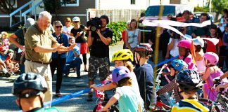 Mayoral Challengers Face Uphill Battle To Satisfy Market Urbanists Mayor Mike McGinn cutting the ribbon on the Ballard Neighborhood Greenway as kids on bikes line up to get a first ride. (Credit: Dennis Bratland)