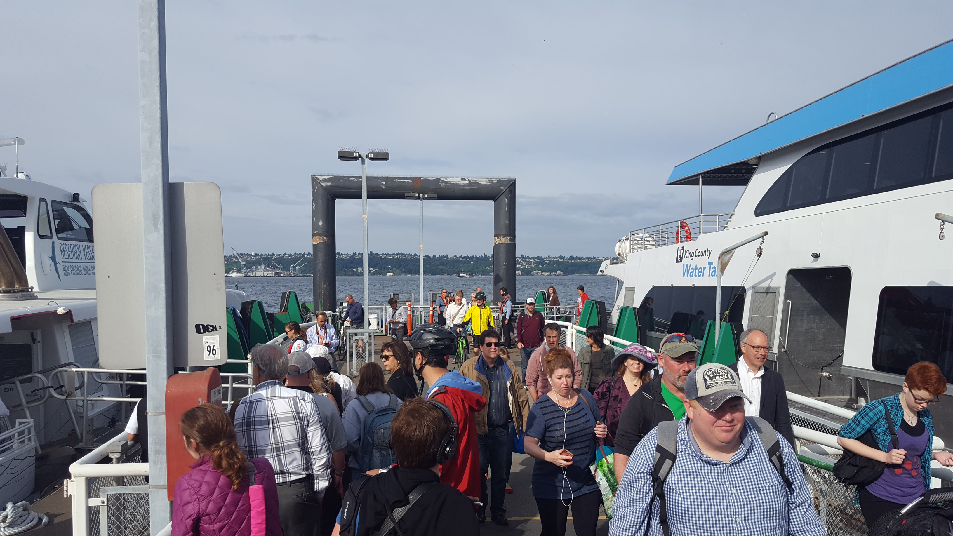 Passengers on Colman Dock with a ferry docked.