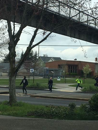 Students crossing Holman Rd NW at-grade below the underpass. (City of Seattle)