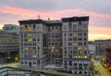Op-Ed: Inquest into Faletogo Killing Highlights Seattle Police Accountability Failures A ten story building with a pinkish purple sunset in the background