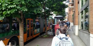A long line of riders wait to board a Route 8 bus at Denny and Westlake. (Photo by Doug Trumm)