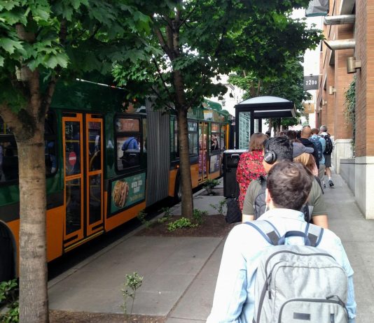 Judge Grants I-976 Injunction, Pausing Transit Cuts A long line of riders wait to board a Route 8 bus at Denny and Westlake. (Photo by Doug Trumm)