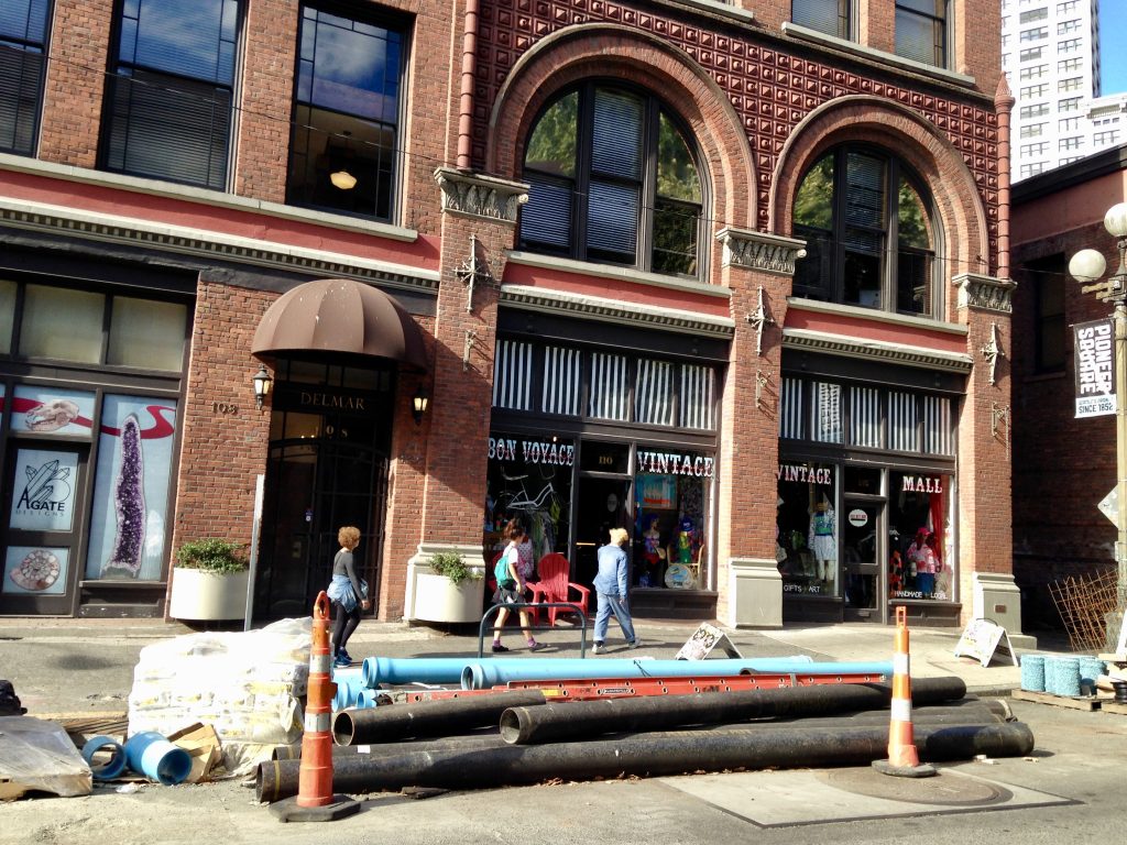 Bon Voyage Vintage in the Del Mar Building of Pioneer Square. Opened in 1891, the building housed an upper floor hotel, ground floor pharmacy, and Chinese laundry in the basement. Seattle used to allow mixed uses in its neighborhoods, including what would now be considered industrial. (Photo by *The Media Gallery*)