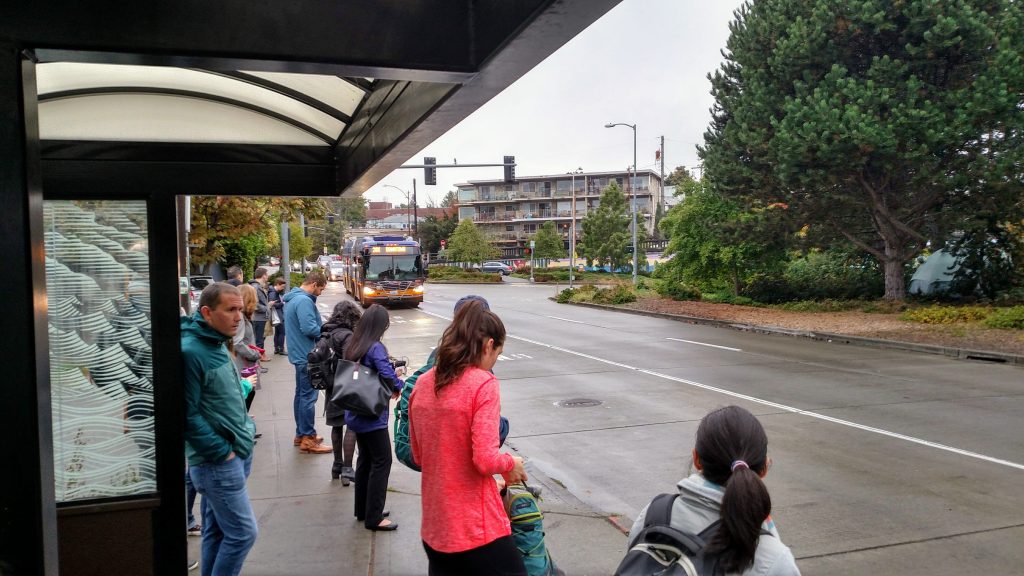 This Fremont bus stop at the Aurora on-ramp near 38th Street could use more service not less given wait times and frequent overcrowding. Route 26 will become the peak-only Route 25, lessening service here. (Photo by author)