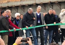 Legislature Must Cut Highway Expansion and Protect Transit, Safety, Maintenance Funds Inslee holds the scissors and other high-level officials look on outside the SR-99 tunnel in February 2019.