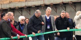 Inslee holds the scissors and other high-level officials look on outside the SR-99 tunnel in February 2019.