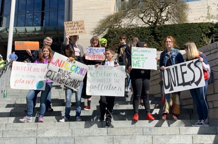 At the first organized Fridays for the Future strike in front of Seattle City Hall a small, but committed group of youth demanded that local government take action on climate change by investing in affordable housing and free public transit. Photo by author.