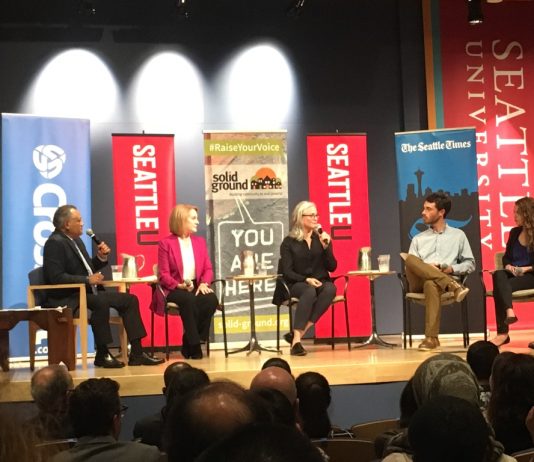 MASS Coalition Sponsors Series of Council Candidate Forums Jenny Durkan and Cary Moon sit in the middle of the forum with journalists including David Kroman and Heidi Groover on the wings.
