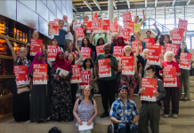 Tenant Advocates Win Seattle Eviction Ban Extension and Press for Broader Reforms Advocates hold red signs backing rent control and housing the homeless.