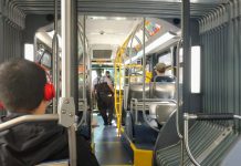Fare Enforcement on First Day of School Reinforces Need for Reform Two fare enforcement officers work their way toward the front of a bus after checking a few riders proof of payment.
