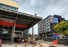 The Roosevelt Rush: Building Boom Anticipates Light Rail’s Arrival Roosevelt light rail station entrance with a 6-story apartment building in the background.
