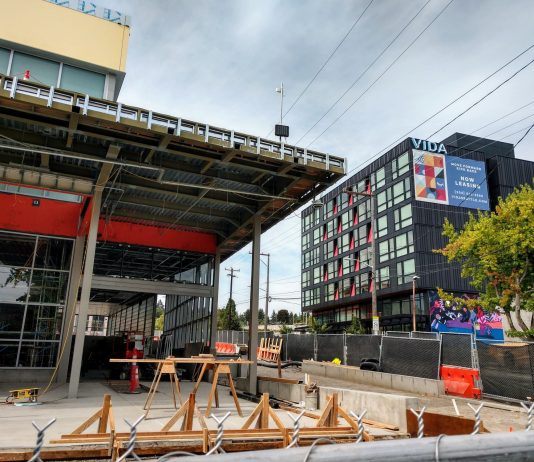 The Roosevelt Rush: Building Boom Anticipates Light Rail’s Arrival Roosevelt light rail station entrance with a 6-story apartment building in the background.