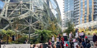 About a 100 people rallied against Amazon for trying to buy the Seattle City Council elections. (Photo by Doug Trumm)