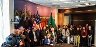 Mayor Jenny Durkan signs the Fare Share Plan into law at city hall. (Photo by Doug Trumm)