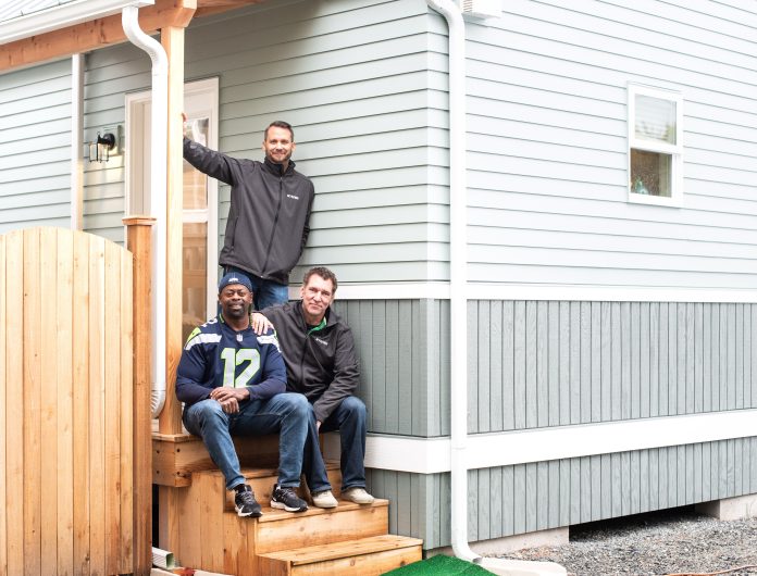 Photo outside house with MyKabin and owner