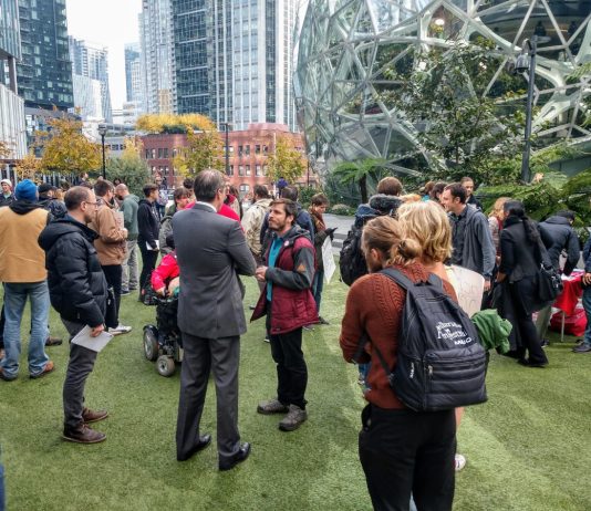 Most Progressive Seattle City Council Ever Tainted by Failure to Elect Shaun Scott An Amazon contract employee who opposed Amazon's copious campaign spending talks to a reporter. before an October 24th rally at the Amazon Spheres. (Photo by author)