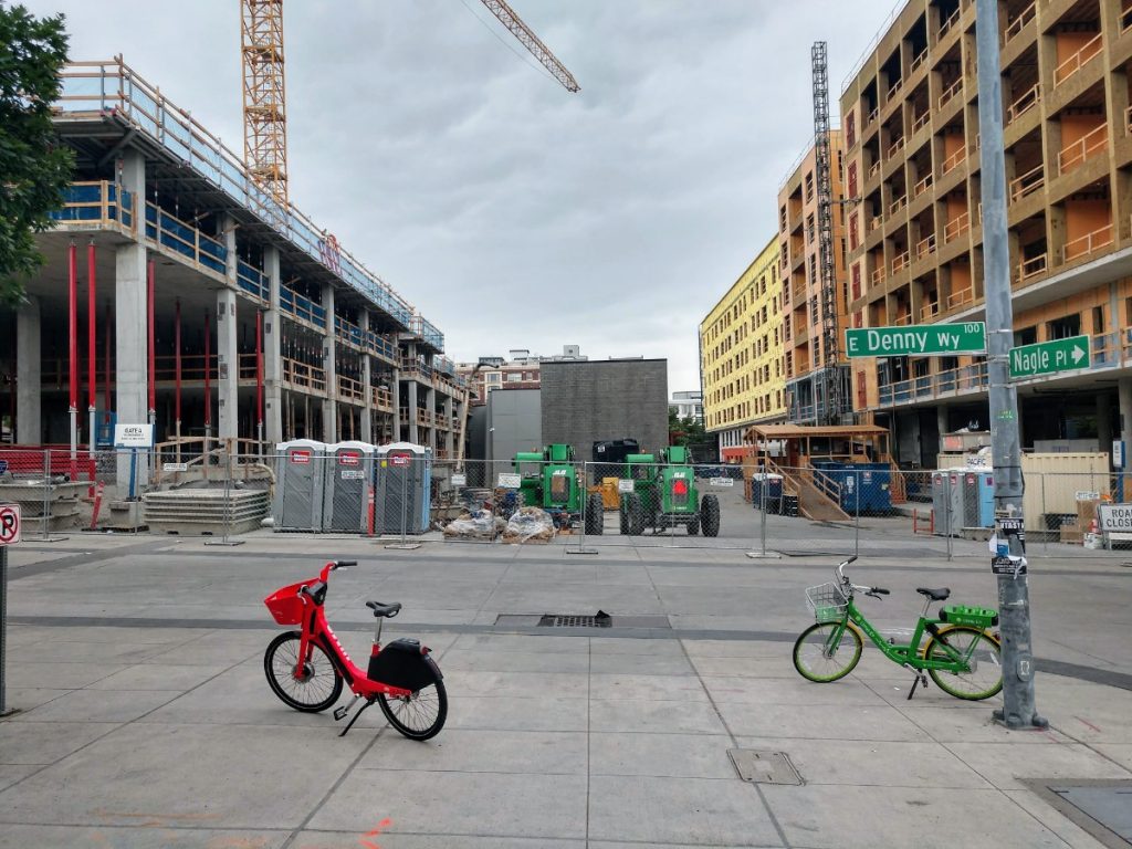 A JUMP bike and a Lime bike site outside Capitol Hill Station. Bikeshare can be a last mile solution connecting transit riders to their final destinations, but it needs to be dependable in every season. (Photo by Doug Trumm)