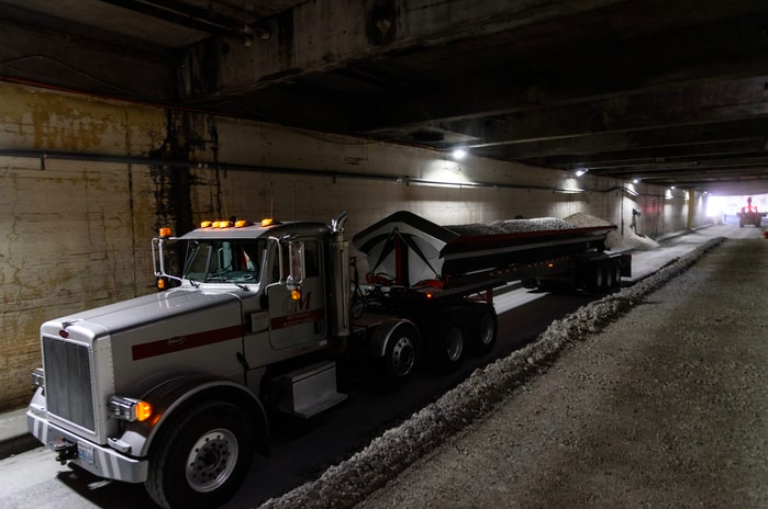 A truck unloads rubble from the demolition of the Alaskan Way Viaduct into the tunnel. WSDOT has warned of increased noise, dust and vibration around the tunnel site as crews work to decommission tunnel. Currently the project is expected to be complete late 2020 or early 2021, pathing the way for the future Battery Portal Park. (Credit: WSDOT )