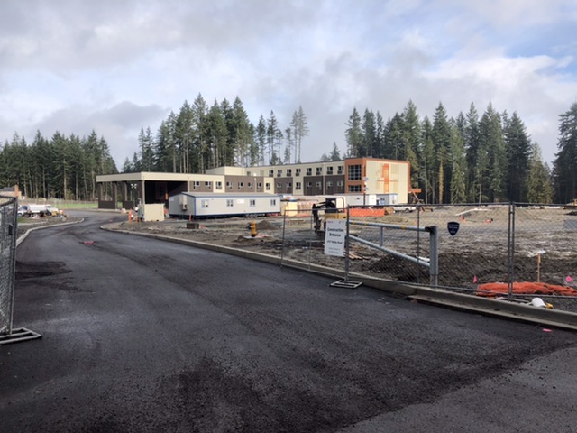 Photograph of the new Ruby Bridges elementary school under construction. Most of the building is up with a lot of site work to be done.