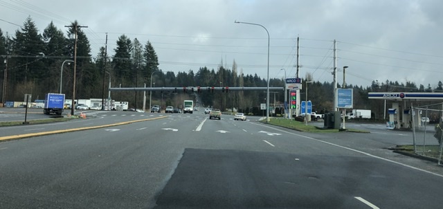 Photograph of an intersection between six lane roads. Really, it’s mostly asphalt and gas stations. 