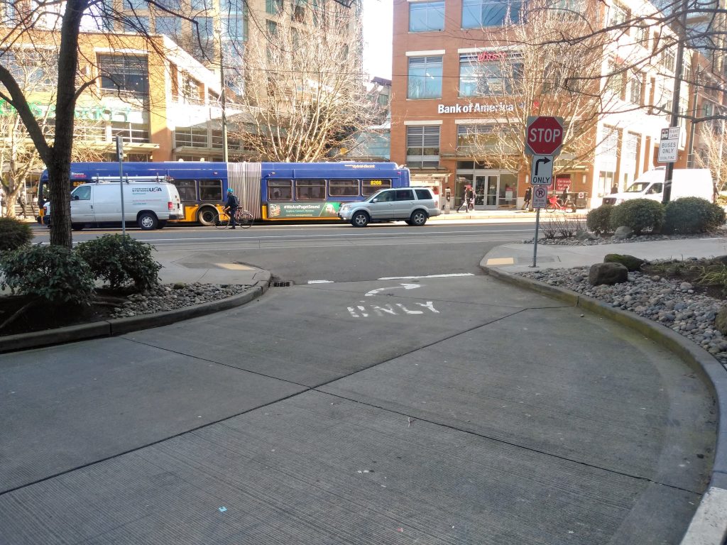 An extended transit stop would bridge either sides of 9th Avenue with a raised crosswalk to communicate the space as for pedestrians. (Photo by the author)