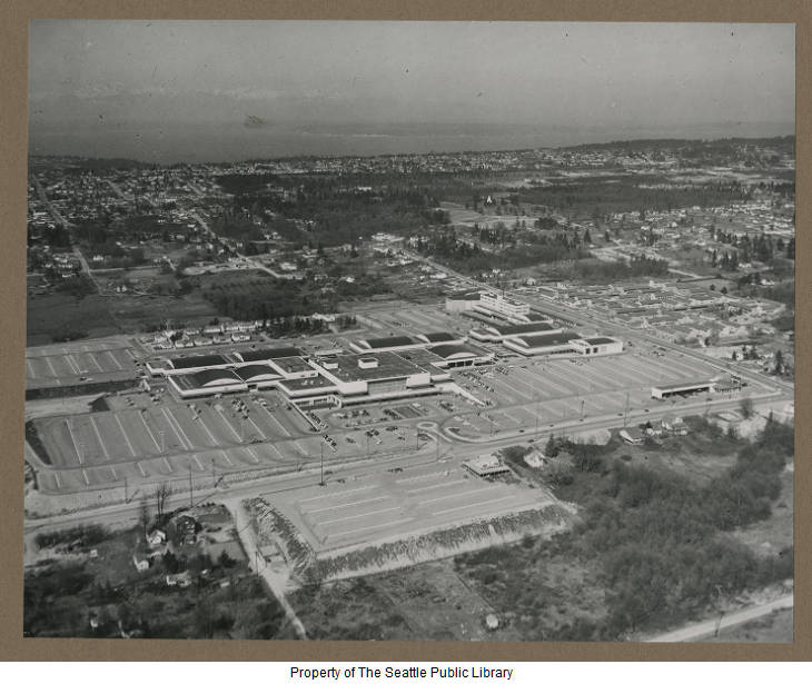 An early aerial view of the 60 acre Northgate Shopping Center. The original design included 3,500 parking spaces. After the completion of Interstate 5 in 1965, about 50,000 cars visited Northgate daily during its commercial peak. (Credit: Seattle Public Library Special Collections)