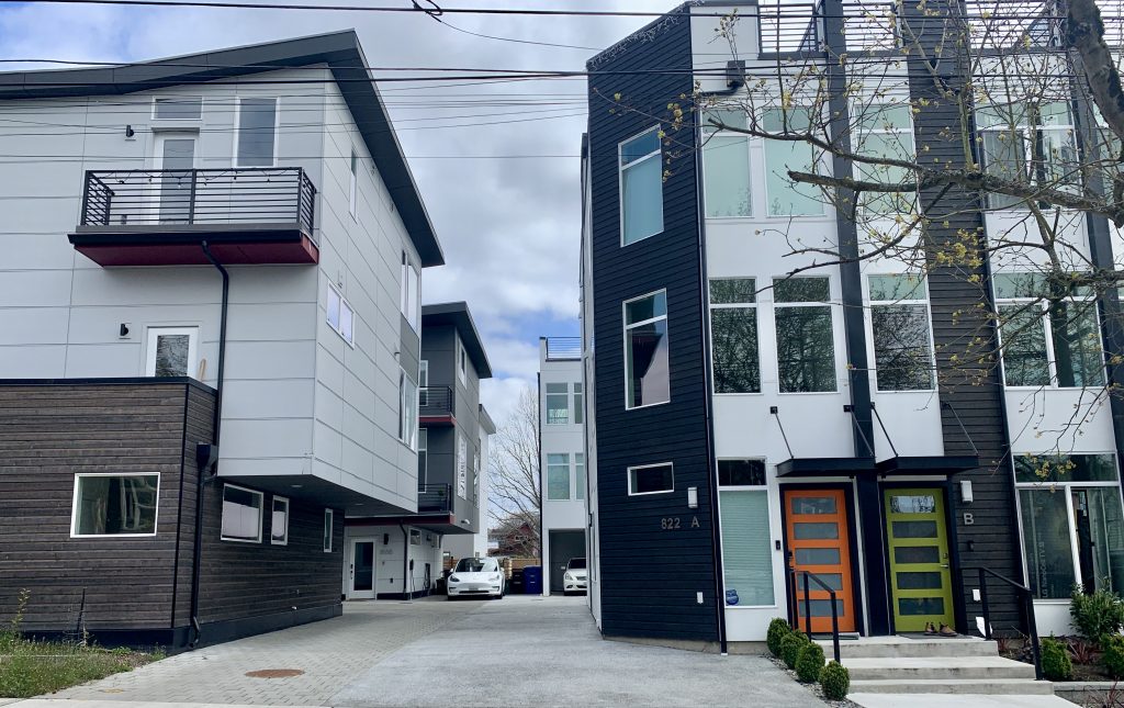 Two recently newer townhouse developments share a central driveway. (Photo by author)