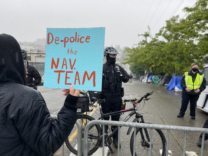 Police were out in force to barricade onlookers from a sweep of Weller Street in the CID. (Photo by Enrico Doan)