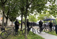 Seeking a Defund Mechanism as Mayor and Police Chief Fortify in Opposition Police gathered in large numbers to ensure houseless were swept and cleared in rapid fashion with no interruption from encampment residents or their allies. (Photo by Enrico Doan)