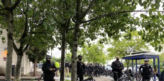 Police gathered in large numbers to ensure houseless were swept and cleared in rapid fashion with no interruption from encampment residents or their allies. (Photo by Enrico Doan)