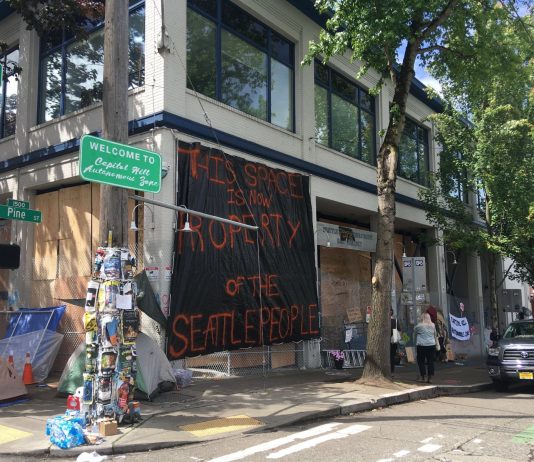Protesters Seize East Precinct and Gain Backing for Siphoning Off SPD Funding "Welcome to the Capitol Hill Autonomous Zone" reads a new sign on Pine Street. (Photo by Michael Goldman)