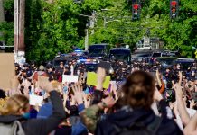 Durkan Declares Seattle Fed-Free, but Her Own Violent ‘Troops’ Dig In Protestors gather behind a police barricade at the East Precinct building, chanting “Hands up, don’t shoot,” on Sunday, May 31.