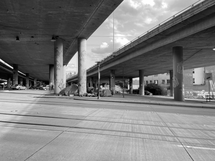 Encampment under I-5 in CID - Photo by Anton Dekom This encampment under I-5 in the International District has since been cleared by the City. (Photo by author)